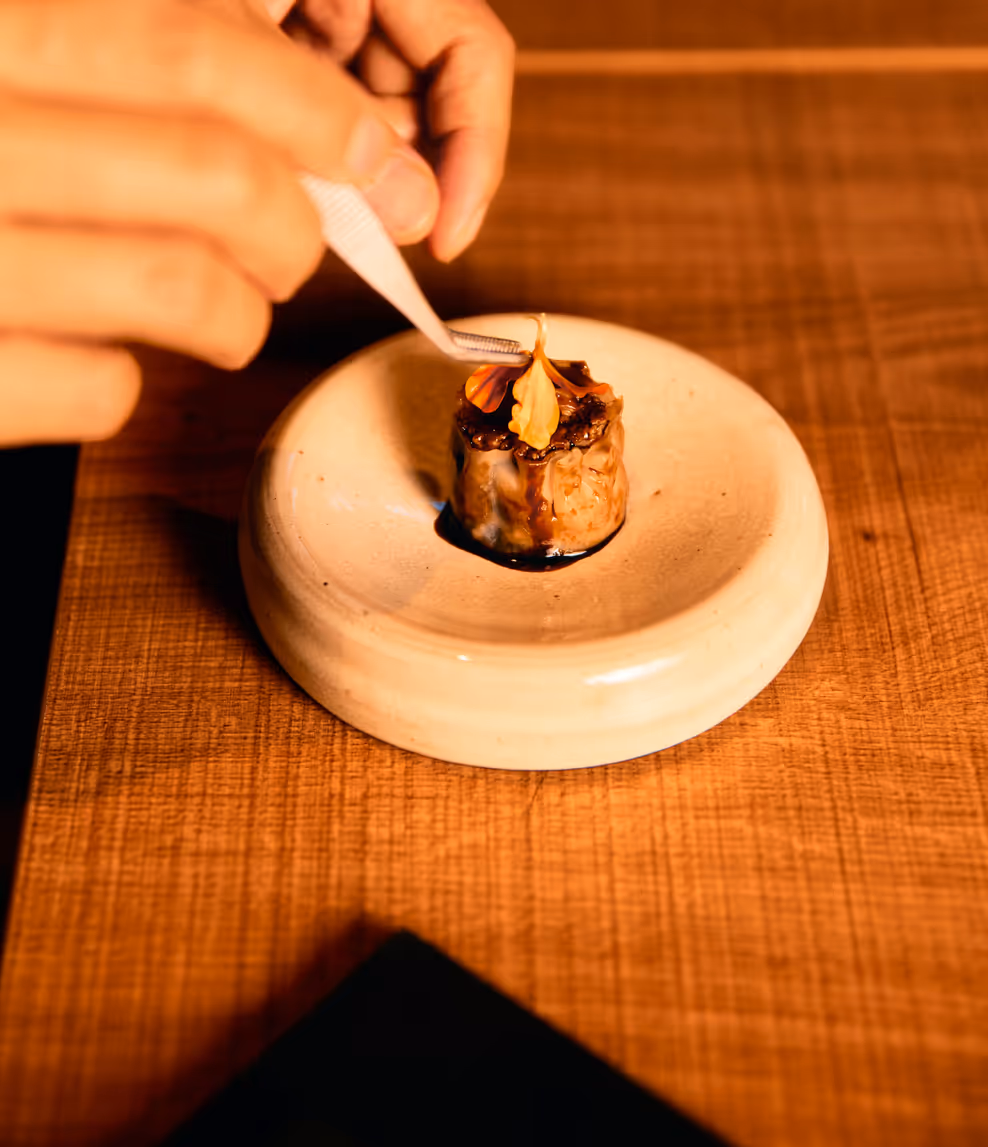 Beef siu mai with dried mandarin peel and black vinegar, finished by hand with tweezers